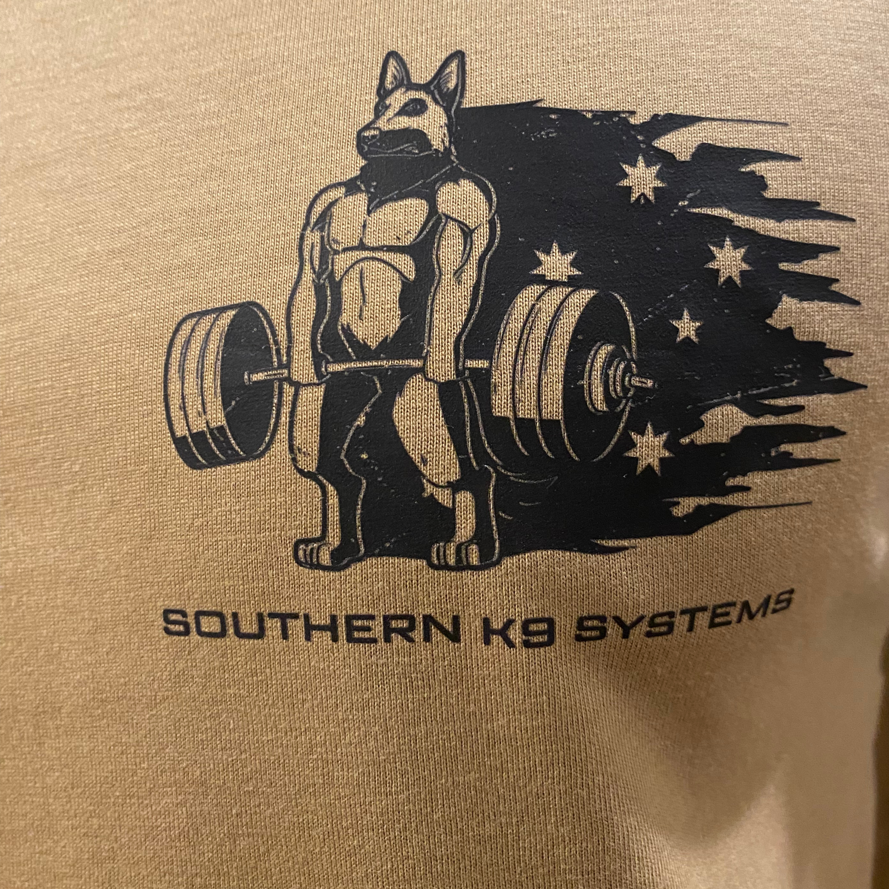 Beige shirt with black graphic of a dog lifting weights and 'Southern K9 Systems' text.