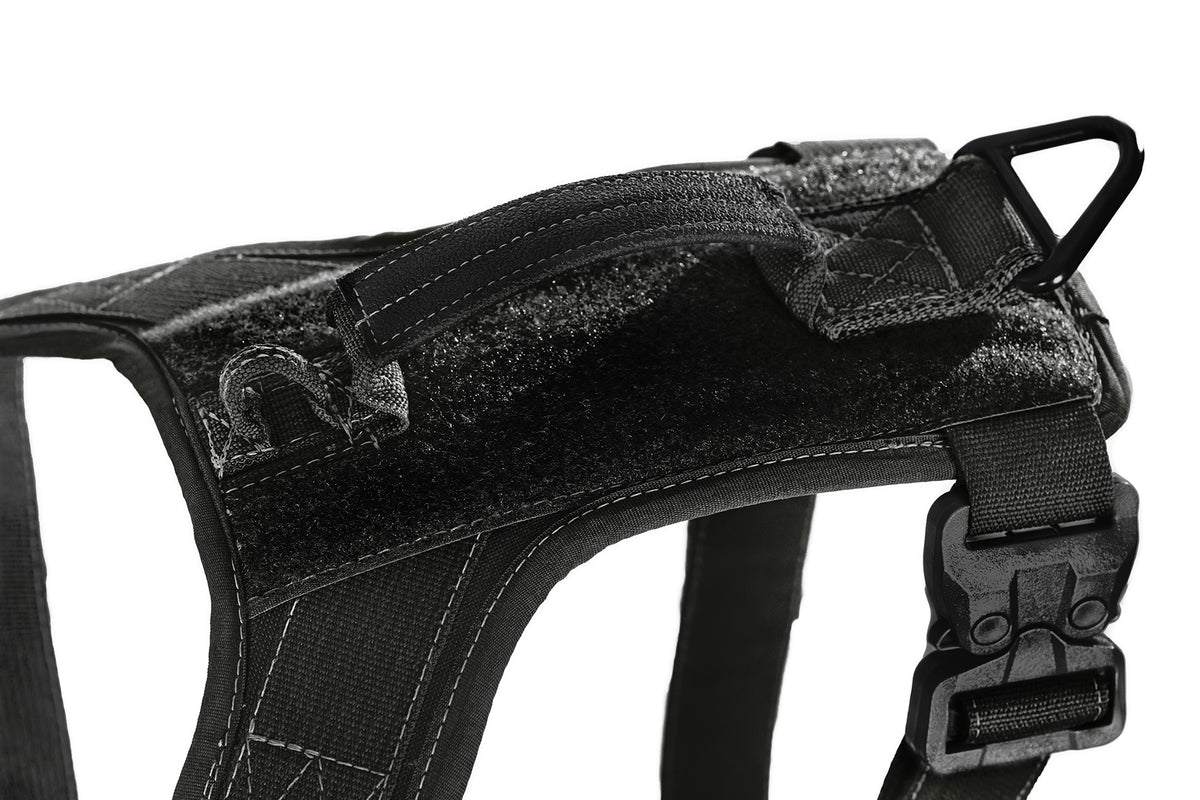 Black tactical dog harness on a white background